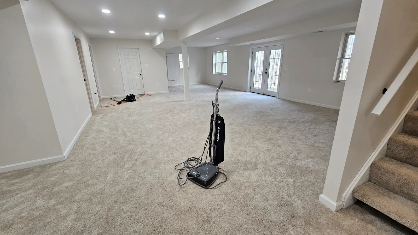 Large carpeted room while cleaning equipment is in use